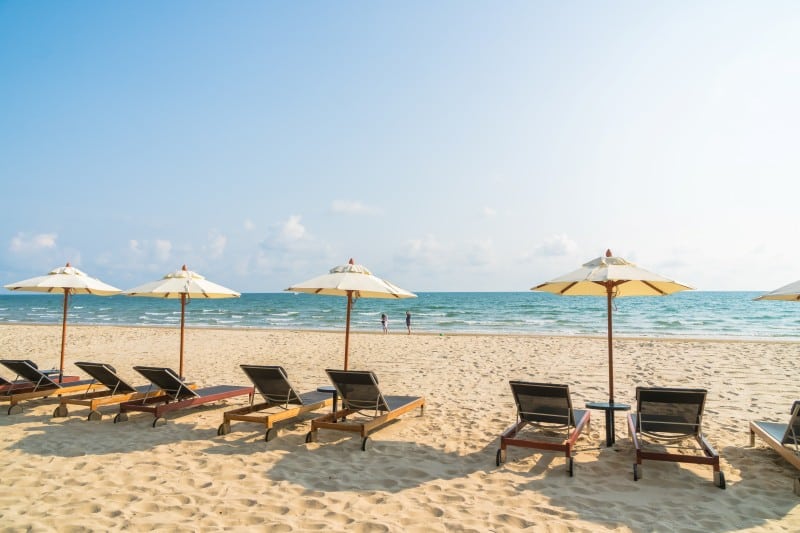 Empty beach chairs and umbrellas facing the ocean on a sunny day, promoting relaxation and beach fun at Fun Crafts ThunderOnTheGulf.