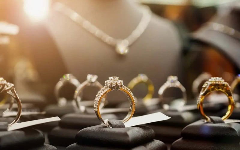 Diamond engagement rings displayed on stands inside a jewelry store, showing craftsmanship quality in Fine Jewelry selection.