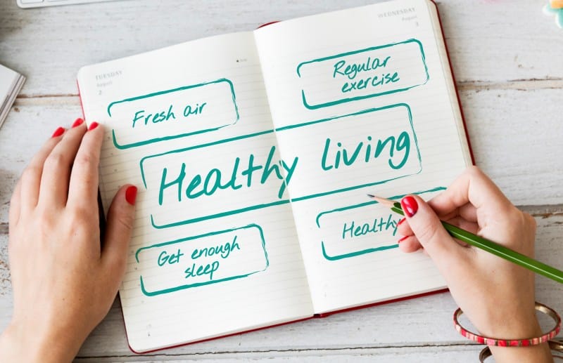 Notebook showing healthy living habits like fresh air, regular exercise, and sleep, representing evidence based wellness guidance from TimesHealthMag.com.
