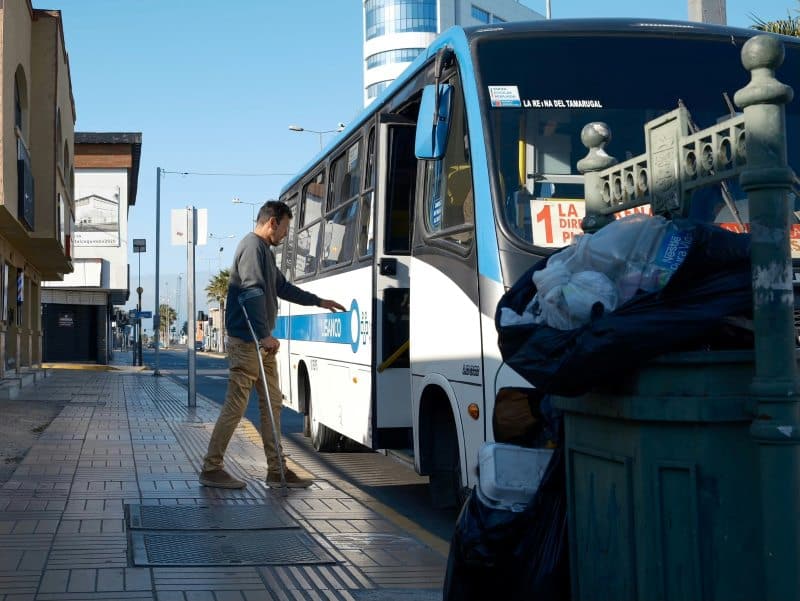 Injury affecting work as man with crutches boards bus showing mobility issues impacting daily job and routine