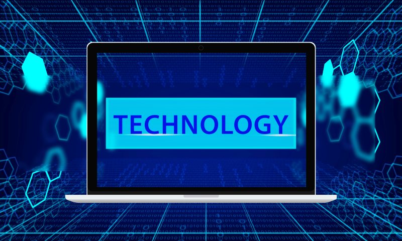 Tech TheBoringMagazine concept showing laptop screen with technology text, digital grid, and data network background.