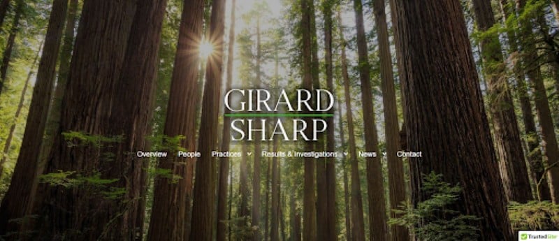 Girard Sharp law firm website homepage showing its name over a forest background.