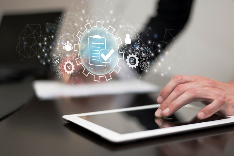 Top 7 AI Contract Intelligence Tools for Financial Institutions AI contract management technology displayed on a tablet with digital compliance and document processing icons.