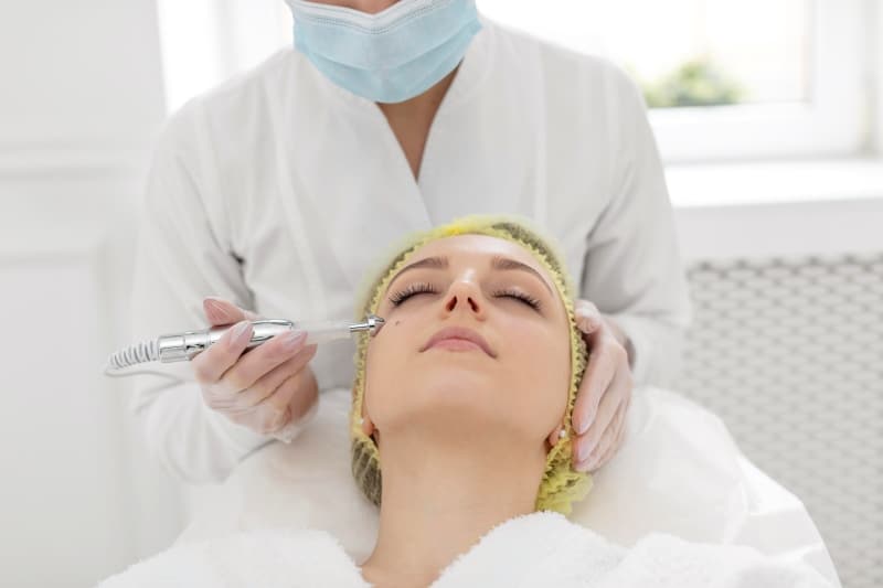 The Complete Guide to Cellular Rejuvenation and Accelerated Skin Recovery Woman receiving a professional facial treatment to support cellular rejuvenation and skin recovery.