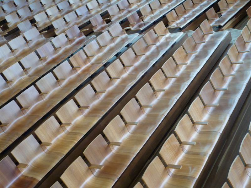 Commercial Furniture as a Capital Asset: Lifespan, Depreciation and Replacement Planning Rows of wooden commercial furniture seating arranged in a large auditorium or lecture hall.